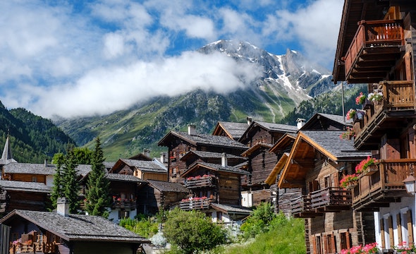Beautiful Swiss chalet with wooden architecture and mountain backdrop